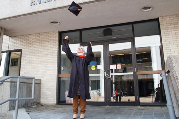 hanan throwing her graduation cap up in the air